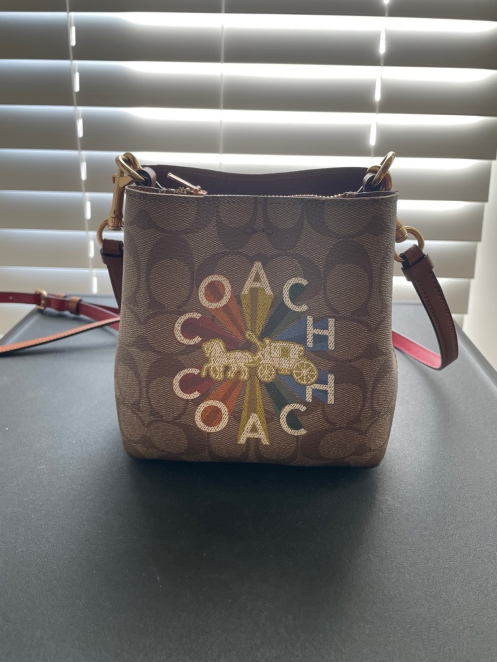 Coach Brown Signature Crossbody bucket bag with Multicolor Logo Burst